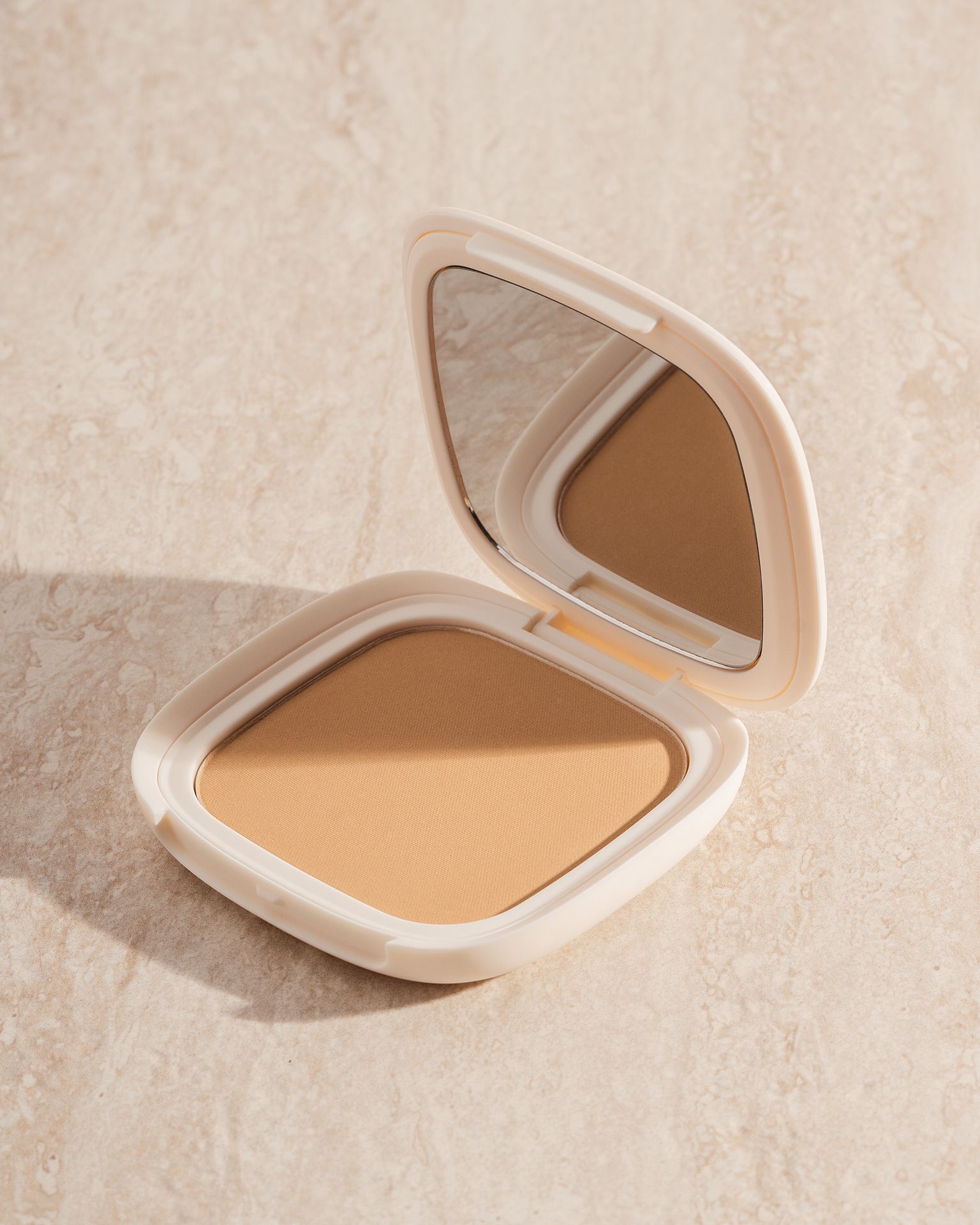 Vesca Rio bronzer hero shot with warm tropical lighting and vibrant styling