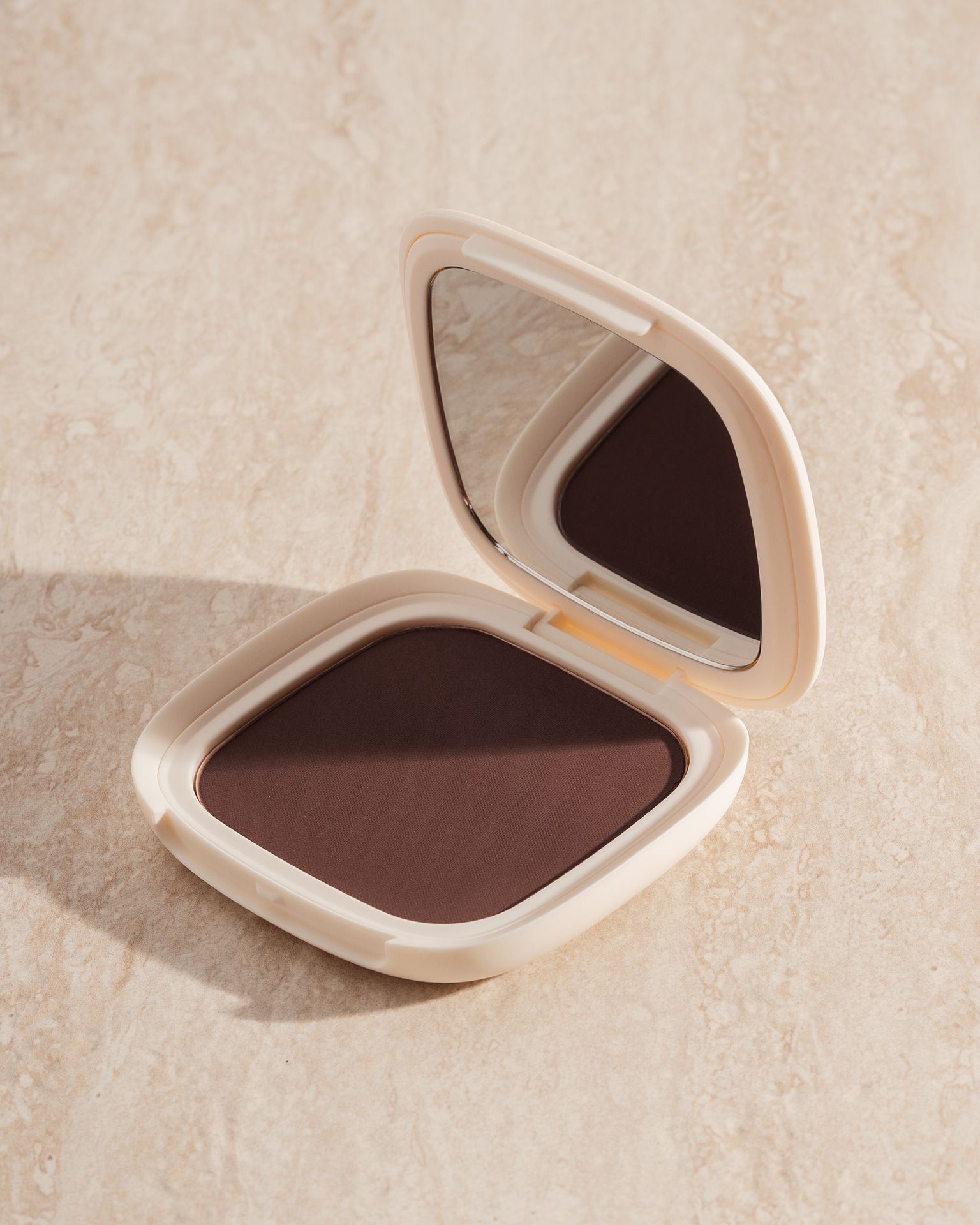 Vesca Tahiti bronzer hero shot with oceanic golden hour lighting