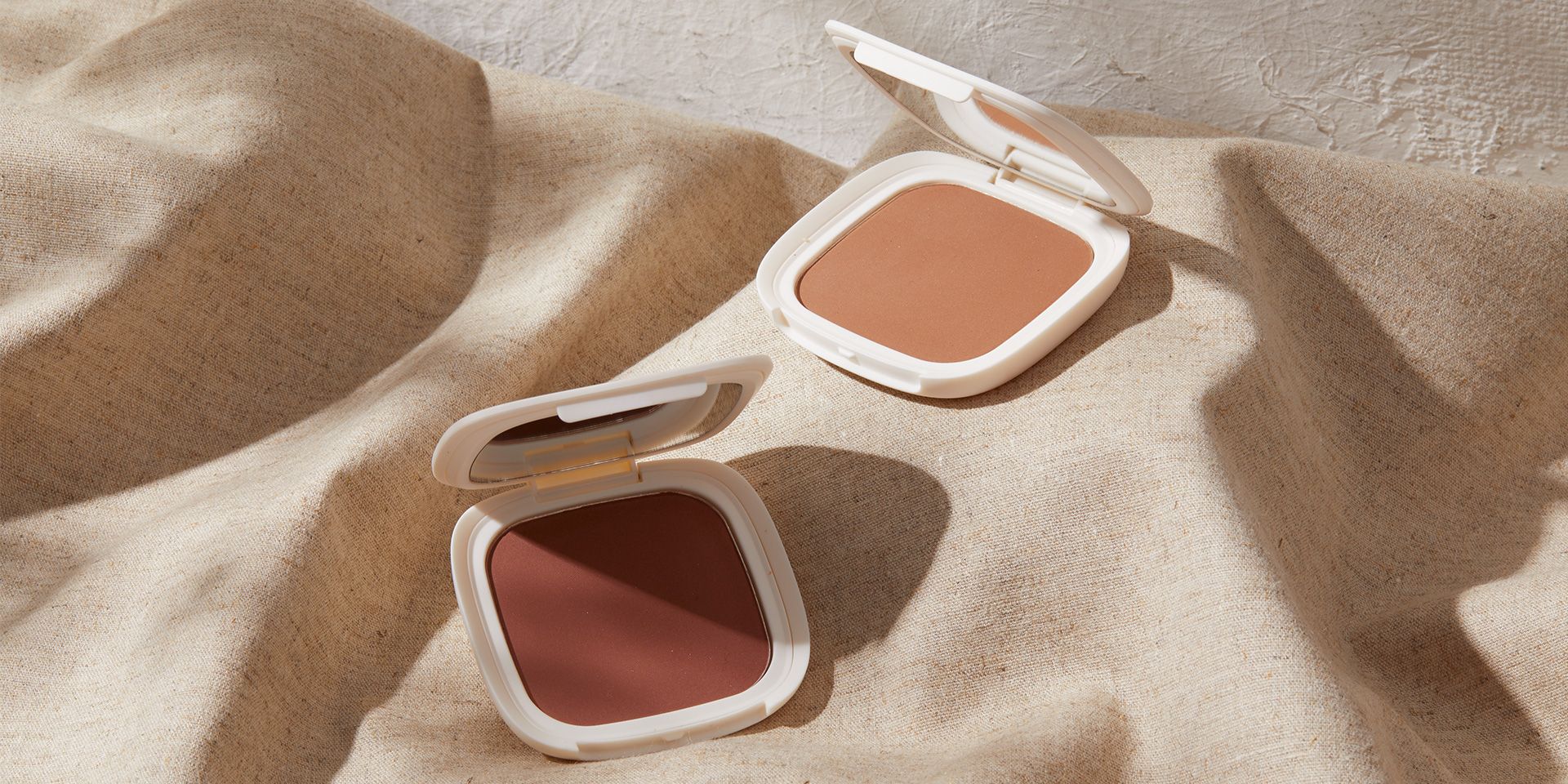 Vesca bronzer styled product photography with warm atmospheric lighting